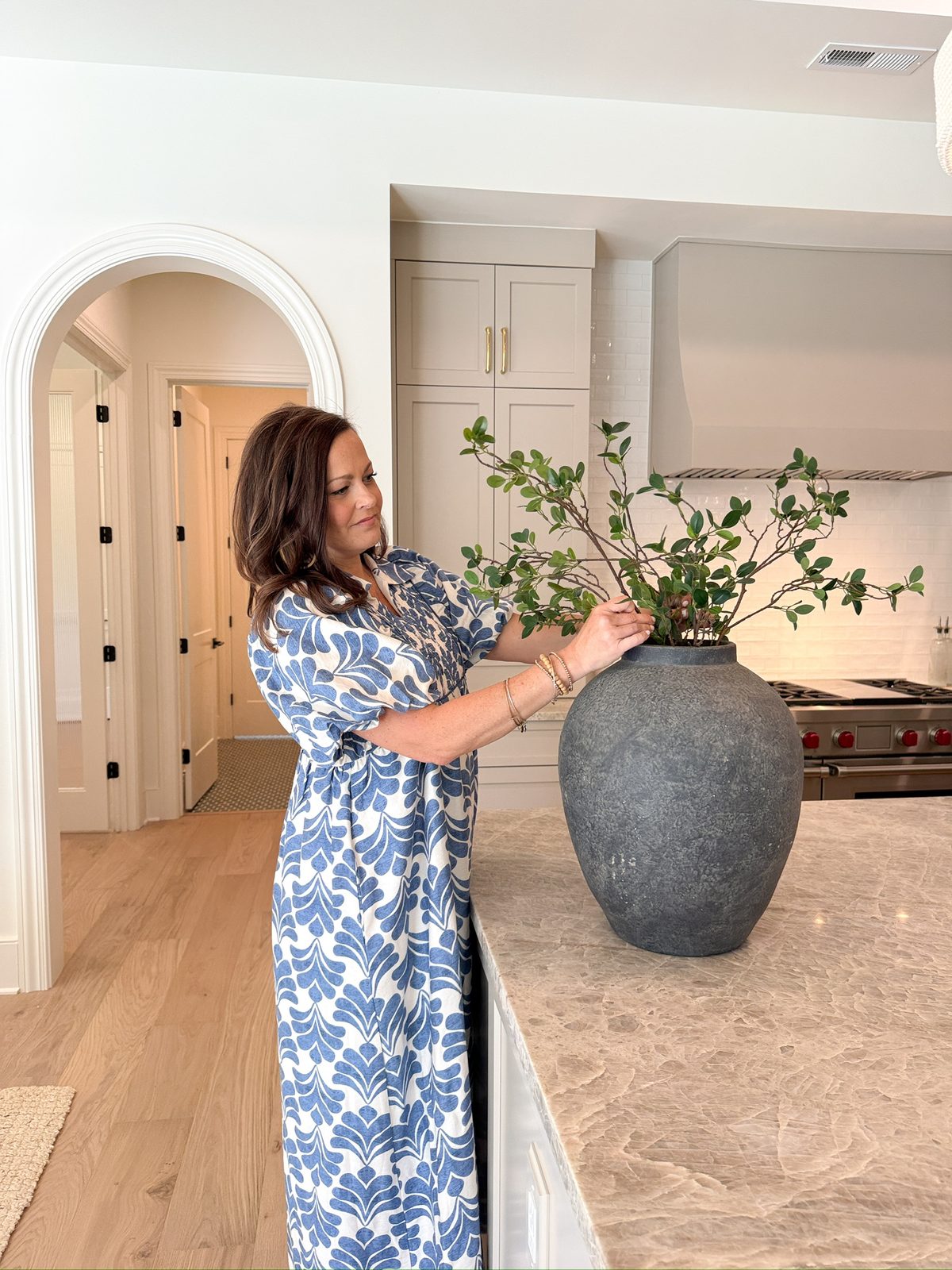 Kellee styling a kitchen island before a listing photo shoot